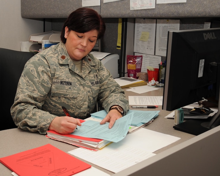 Maj. Karen Nzerem, 2nd Aerospace Medicine Squadron primary Personnel Reliability Program competent medical authority, fills out an annual audit form on Barksdale Air Force Base, La., Jan. 15. Nzerem was named Outstanding PRP CMA of the Year. She distinguished herself and her team by eliminating a certification back log which consisted of hundreds of cases, and accurately maintains and reviews over 1,500 records. (U.S. Air Force photo/Senior Airman Sean Martin)