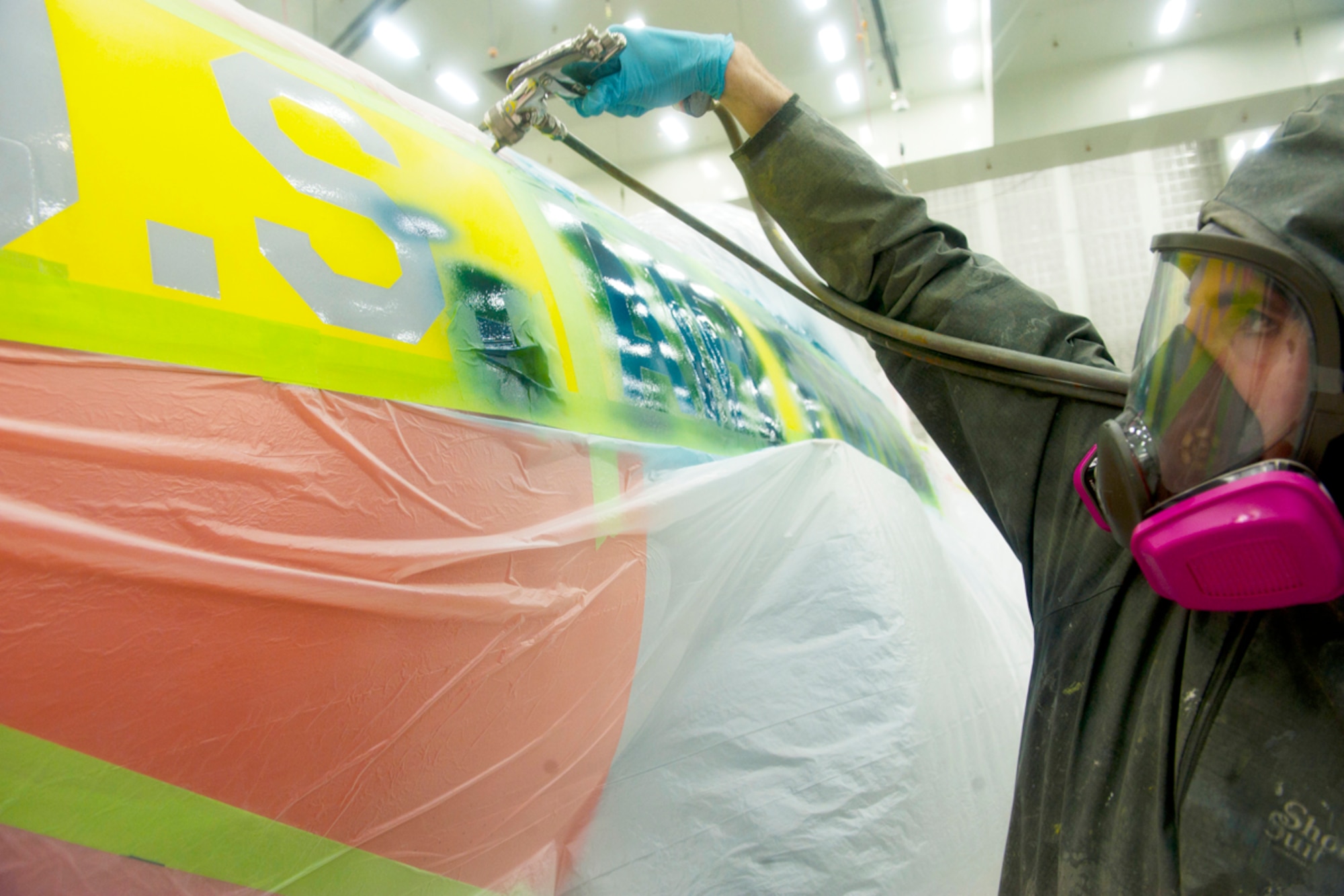 Airman 1st Class Cody Frank paints “U.S. Air Force” onto the side of a Lockheed T-33A Shooting Star in Hangar 21 on JBER Feb. 7. The T-33A is the first of several static displays from Heritage Park to get refurbished. Frank is a 3rd Maintenance Squadron aircraft structural maintenance apprentice from Georgetown, Ky. (U.S. Air Force photos/Staff Sgt. Robert Barnett)
