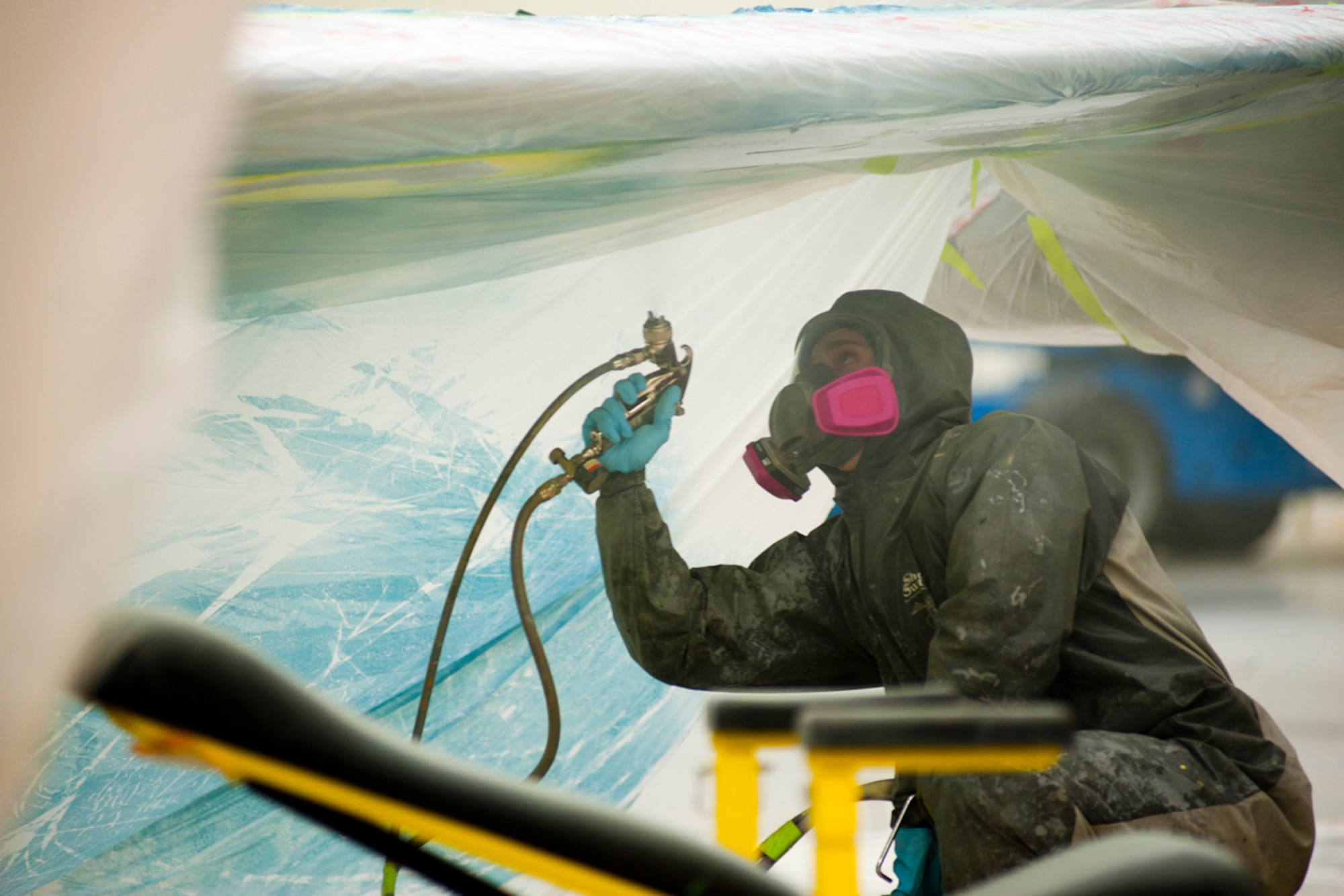 Senior Airman Matt Smith paints the underside of a Lockheed T-33A wing in Hangar 21 on JBER Feb. 7. The T-33A is the first of several static displays from Heritage Park to get refurbished. Frank is a 3rd Maintenance Squadron aircraft structural maintenance apprentice from Dixon, Calif. (U.S. Air Force photos/Staff Sgt. Robert Barnett)