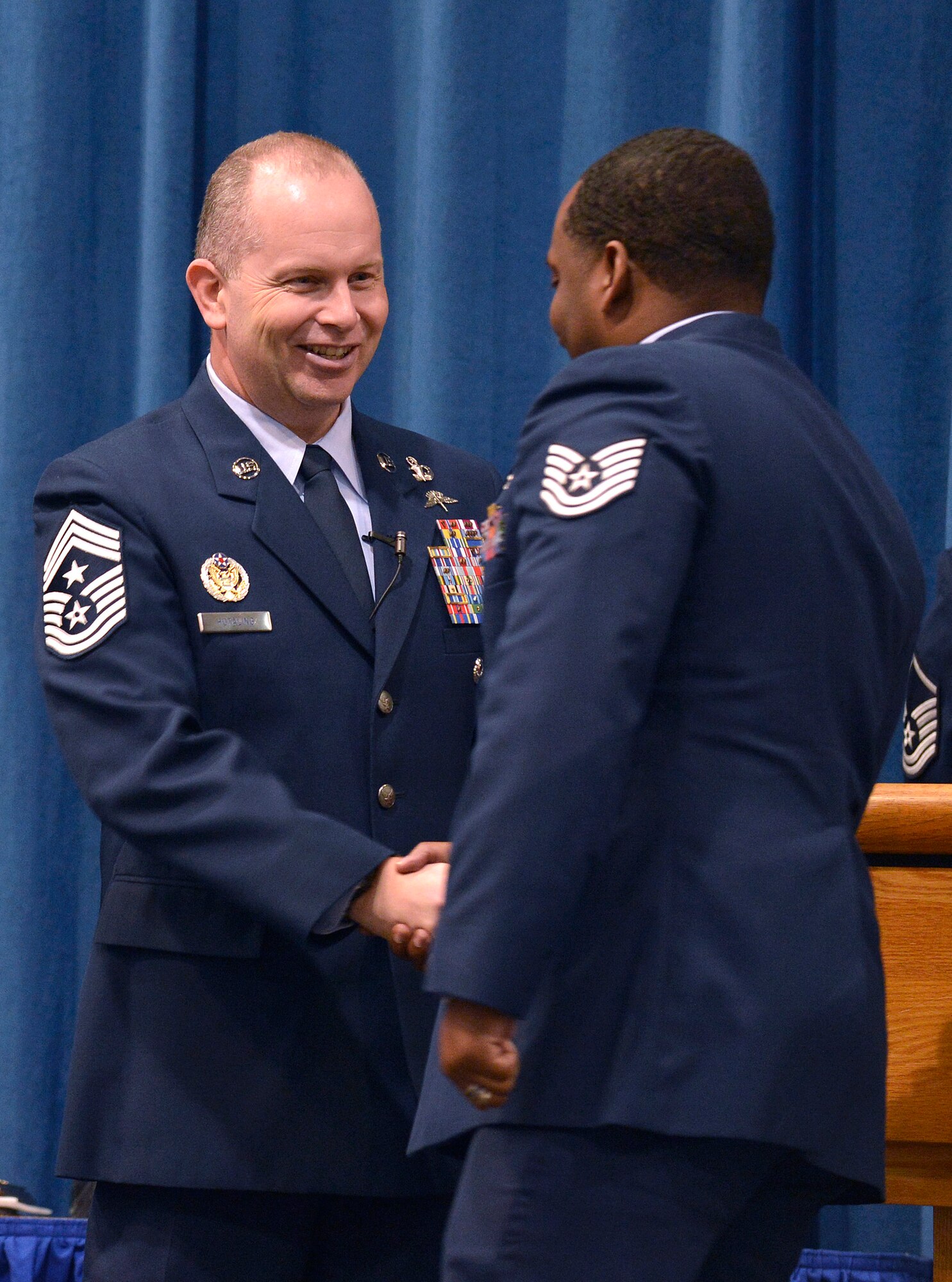 Chief Master Sgt. Jim Hotaling, left, Command Chief Master Sergeant of the Air National Guard shakes hands with graduating Airmen from the EPME academy at the I. G. Brown Training and Education Center here, Feb. 14. Students attending the Noncommissioned Officer Academy and Airmen Leadership School totaled 314 for the six and five week classes. (National Guard photo by Master Sgt. Kurt Skoglund)
