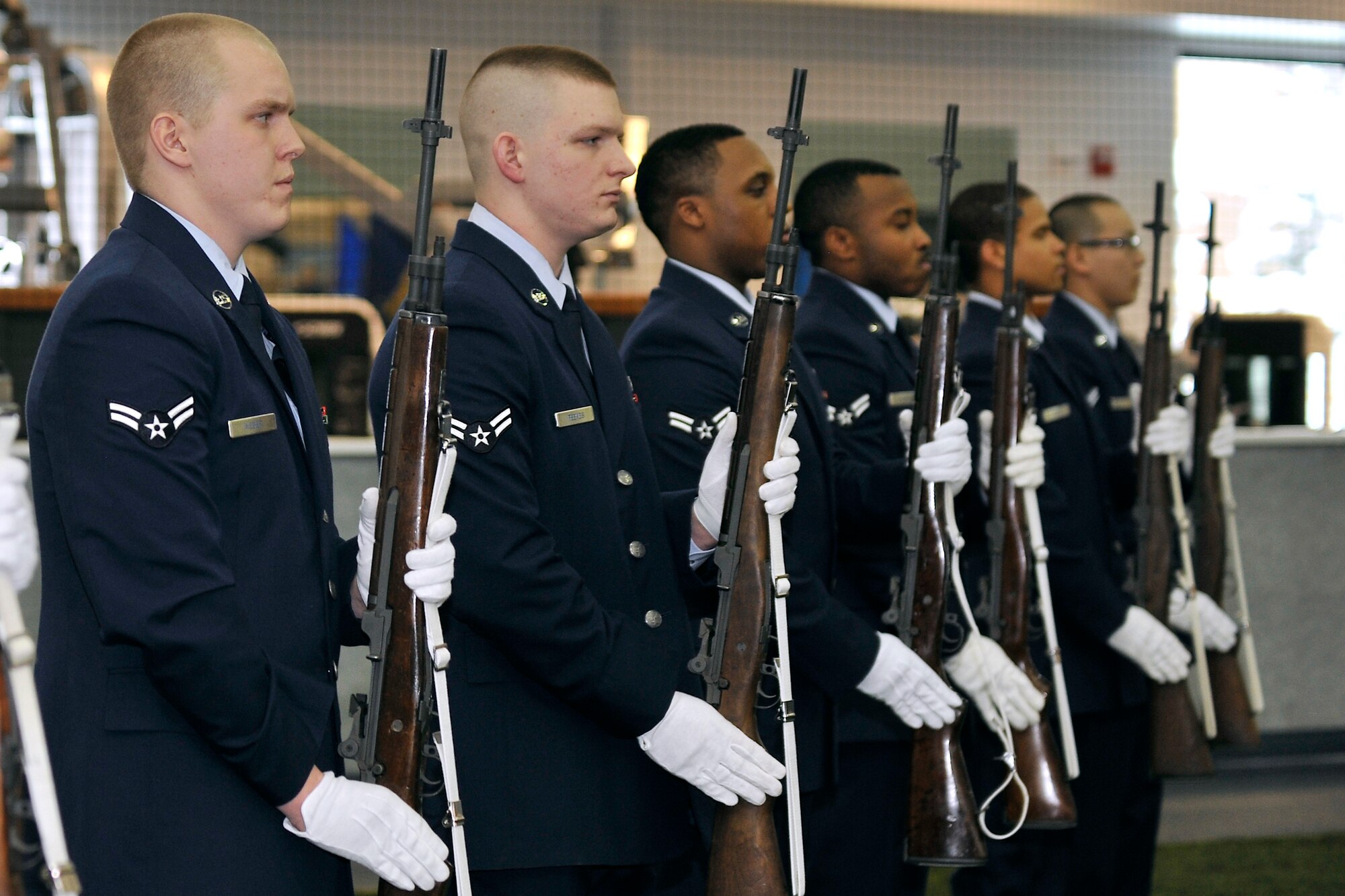 An Eielson Honor Guard firing squadron presents arms during an Honor Guard graduation ceremony Feb. 8, 2013, Eielson Air Force Base, Alaska.  The firing squad performed a simulated military funeral ceremony demonstrating drill movements, military bearing and wear of the ceremonial uniform.   (U.S. Air Force Photo/Senior Airman Racheal Watson)