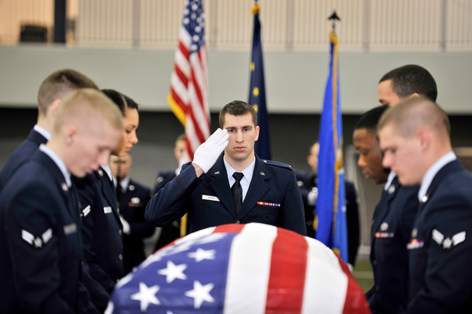 Eielson Honor Guardsmen perform a simulated funeral ceremony at the Baker Field House Feb. 8, 2013, Eielson Air Force Base, Alaska.  As part of the Honor Guard graduation ceremony the graduates demonstrated  their training in colors, firing squad and pallbearer.  (U.S. Air Force Photo/Senior Airman Racheal Watson)
