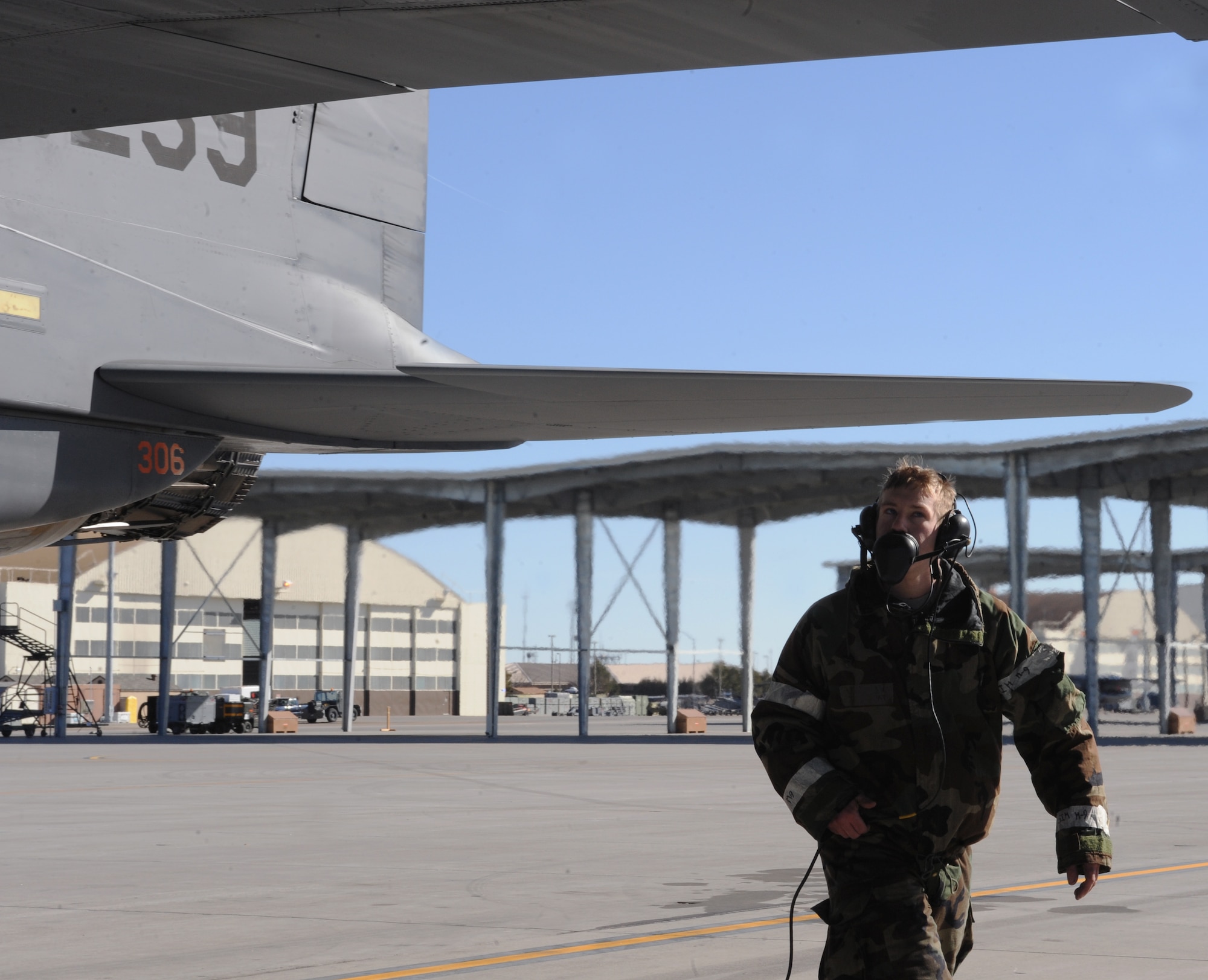 U.S. Air Force Airman 1st Class Jacob Pate, 366th Aircraft Maintenance Squadron crew chief, speaks with the pilot while performing pre-flight checks Feb. 14, 2013, at Mountain Home Air Force Base, Idaho. Ground crews worked in Mission Oriented Protective Posture or MOPP gear while participating in Sharpshooter 13-2. (U.S. Air Force photo/Senior Airman Benjamin Sutton) 