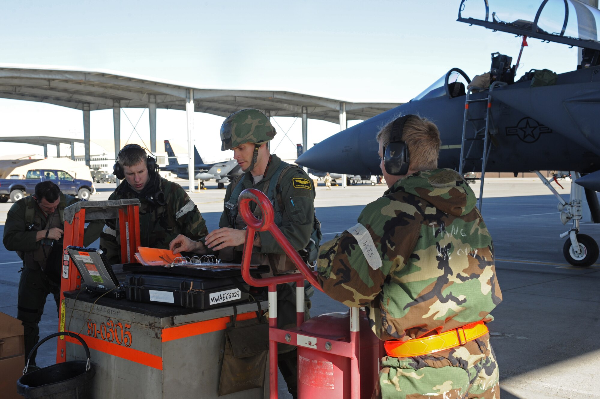 Members of the 391st Fighter Squadron perform safety checks for a combat sortie Feb. 14, 2013, at Mountain Home Air Force Base, Idaho. Aircrews endured added stress in the simulated combat environment of the Sharpshooter 13-2 exercise. (U.S. Air Force photo/Senior Airman Benjamin Sutton) 