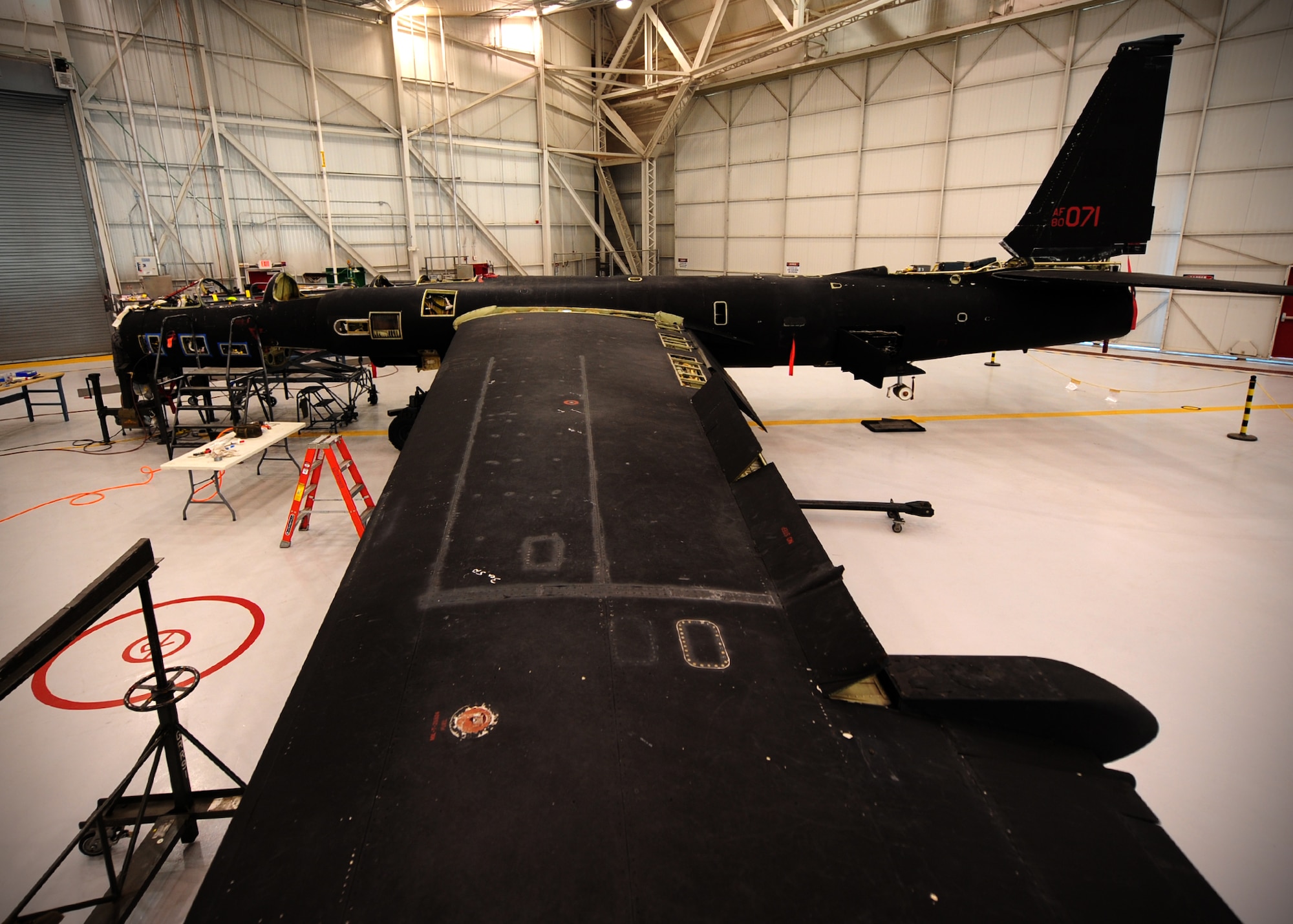 A U-2 Dragon Lady intelligence, surveillance and reconnaissance aircraft sits partially dismantled for Cockpit Altitude Reduction Effort modifications in a phase dock at Beale Air Force Base, Calif., Feb. 14, 2013. The upgrades will almost double the cabin pressure from 3.88 to 7.65 pounds per square inch, improving pilot safety and comfort. (U.S. Air Force photo by Senior Airman Shawn Nickel/Released)