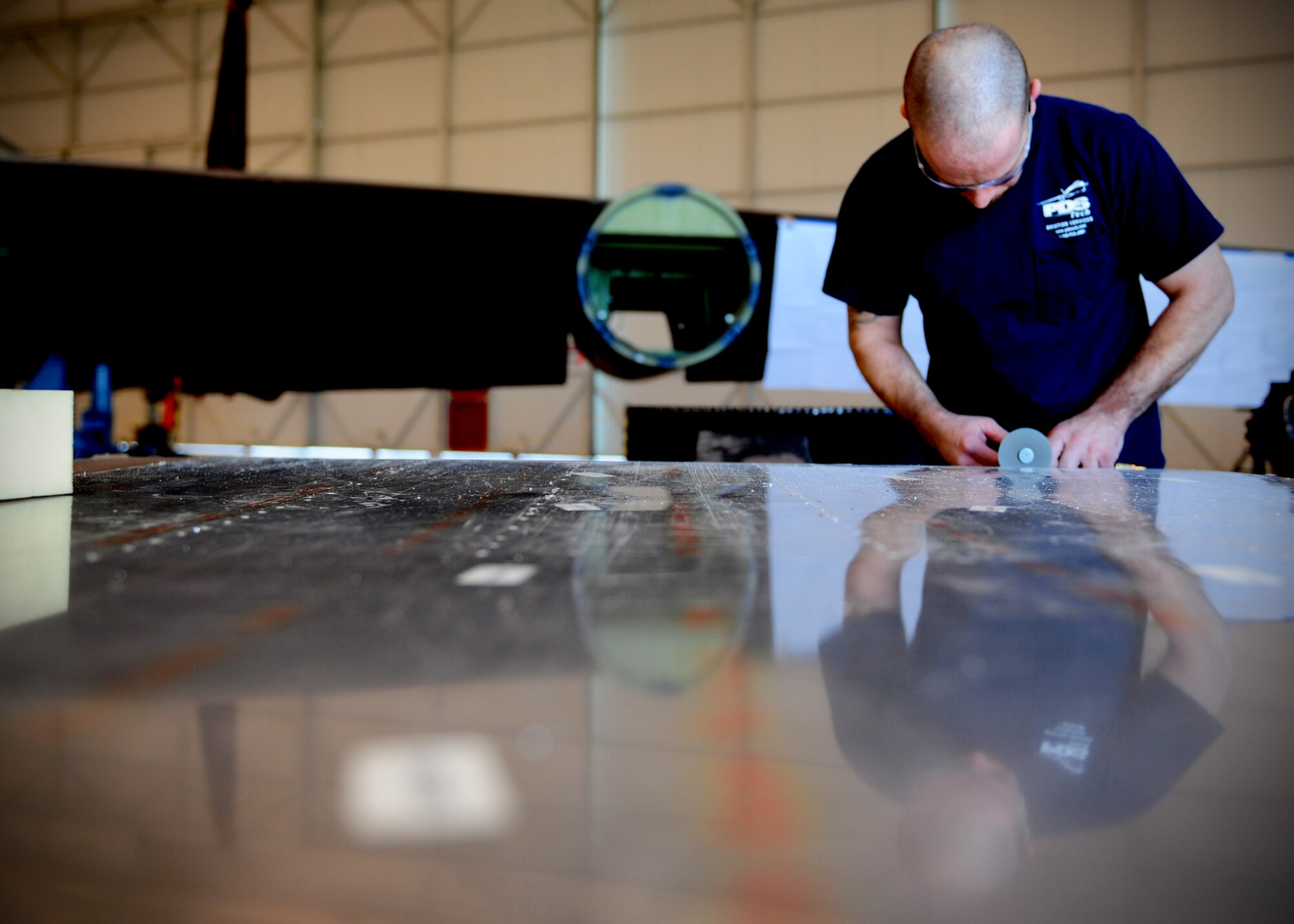 Greg Lonnie, Lockheed Martin aircraft structure mechanic, cuts aluminum to replace a skin piece from under the cockpit of a U-2 intelligence, surveillance and reconnaissance aircraft, at Beale Air Force Base, Calif., Feb. 14, 2013. Liquid from the urine collection device used during long high flights can leak and corrode the plane from the inside out. These parts have to be retrofitted from scratch to match the original specifications during Cockpit Altitude Reduction Effort modifications. (U.S. Air Force photo by Senior Airman Shawn Nickel/Released)