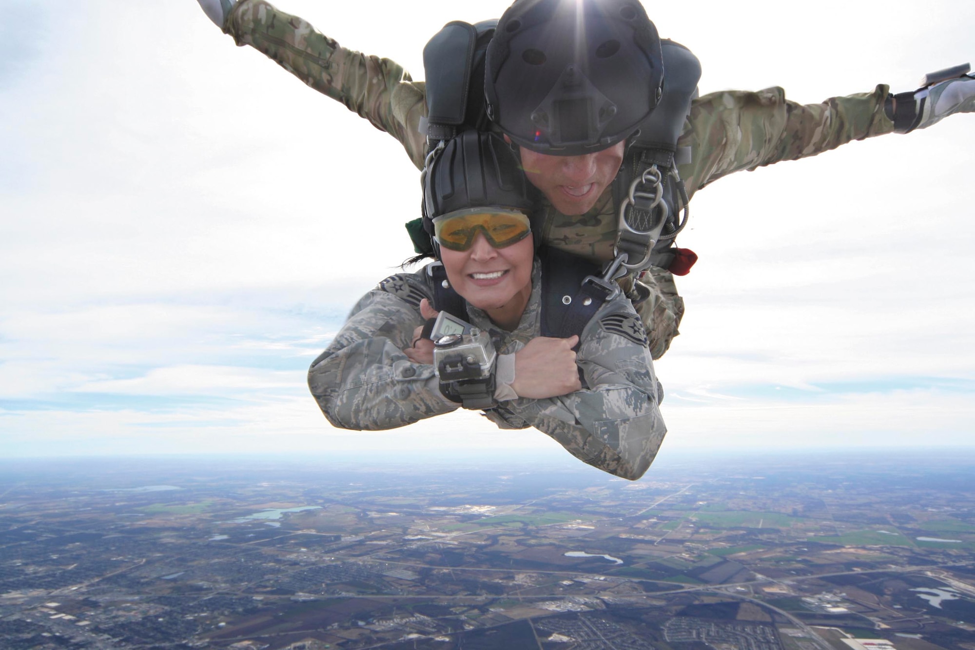 Tandem passenger Staff Sgt. Victoria Lopez smiles during her jump with Kirby Rodriguez, a tandem master jumper and personnel parachute program manager with the 342nd Training Squadron. Lopez is a military training leader with the 37th Training Group. Both are at JBSA-Lackland.  (U.S. Air Force photo by Tech. Sgt. Marc Esposito)