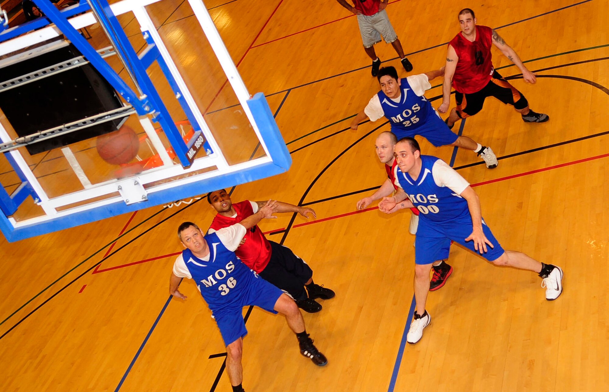 Airmen from the 100th Maintenance Operations Squadron and 100th Force Support Squadron prepare to gain control of a rebound during an intramural basketball game Feb. 14, 2013, at the Hardstand Fitness Center, RAF Mildenhall, England. The 100th MOS won the game with a final score of 41-23. (U.S. Air Force photo by Senior Airman Ethan Morgan/Released)