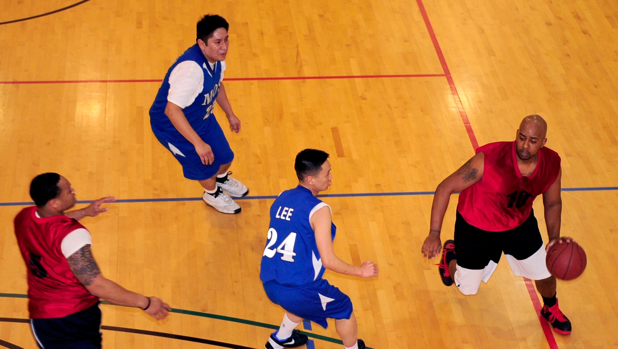 Staff Sgt. Andre Goss, 100th Force Support Squadron fitness specialist from Portland, Ore., drives the ball toward the hoop during an intramural basketball game Feb. 14, 2013, at the Hardstand Fitness Center, RAF Mildenhall, England. The 100th FSS played off against the 100th Maintenance Operations Squadron with the 100th MOS winning the game 41-23.  (U.S. Air Force photo by Senior Airman Ethan Morgan/Released)