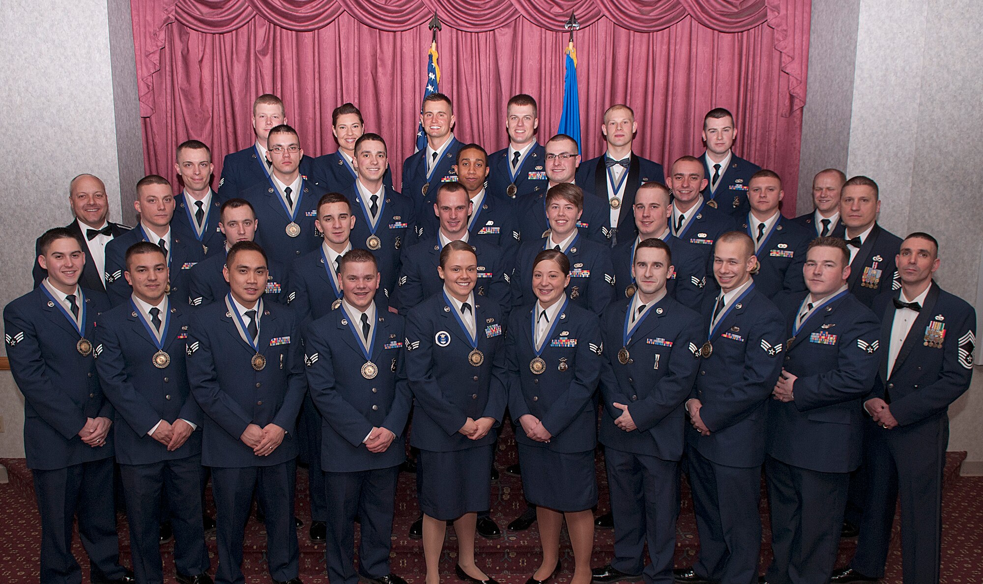 Col. Christopher Coffelt, 90th Missile Wing commander; Chief Master Sgt. Michael Garrou, 90th MW command chief; Chief Master Sgt. Shawn Drinkard, 90th Security Forces Group; and Airman Leadership School Class 13-B graduates pose for a photo during the ALS Graduation Ceremony held Feb. 7 in the Trail’s End Club. (U.S. Air Force photo by R.J. Oriez)
