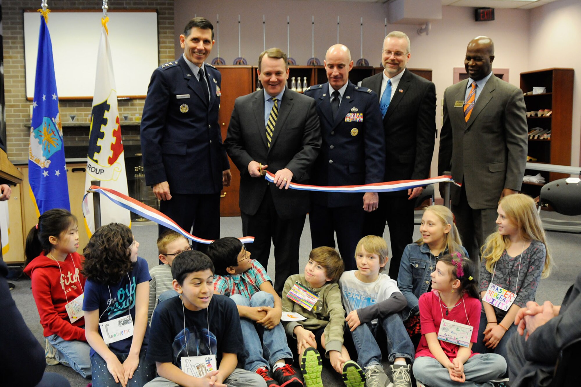 HANSCOM AIR FORCE BASE, Mass. – (left to right) Lt. Gen. C.D. Moore II, Air Force Life Cycle Management Center commander; Massachusetts Lt. Gov. Tim Murray; Col. Lester A. Weilacher, 66th Air Base Group commander; Dr. Peter Holden, Hanscom STARBASE director; and Vic Hayes, 66th Force Support Squadron director, along with Hanscom Middle School fifth graders cut a ribbon signifying the official opening of the Hanscom STARBASE program Feb. 13. STARBASE is a Department of Defense initiative that targets Title I schools and at-risk youth to get them excited about science, technology, engineering and math. (U.S. Air Force photo by Linda LaBonte Britt)