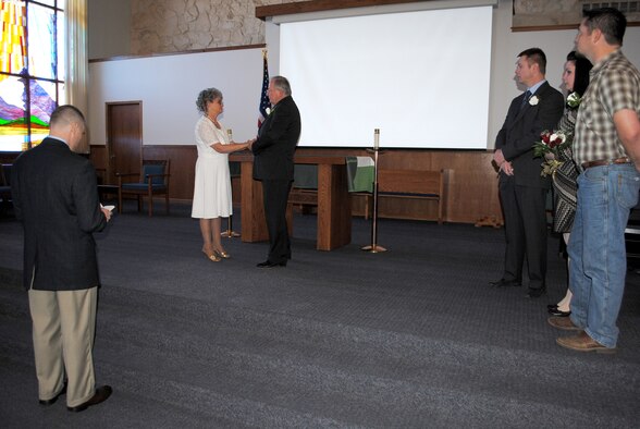 Chaplain (Capt.) Robert Compere, 341st Missile Wing chaplain, far left, officiates Jacque and Dennis Ellingson’s vow renewal ceremony Feb. 8 at the base chapel.  Three of the couple’s five children flew into Montana to witness the ceremony; pictured from left to right are Army Capt. Edward Ellingson, Alena Ward and Eric Ellingson.  (U.S. Air Force photo/Senior Airman Cortney Paxton)