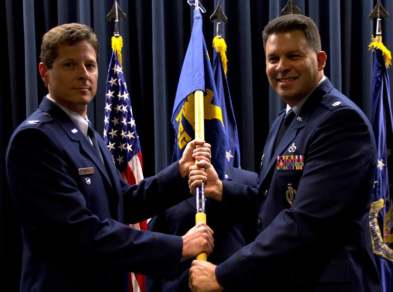 Lt. Col. Marty Hughes, right, accepts the 302nd Mission Support Group guideon from Col. Courtney Arnold, 302nd Airlift Wing vice commander, during an assumption of command ceremony Feb. 9 at Peterson Air Force Base, Colo. Before his assignment to the 302nd Airlift Wing, he served as the commander of the 556th RED HORSE Squadron at Hurlburt Field, Fla.  (U.S. Air Force photo/Staff Sgt. Nathan Federico)