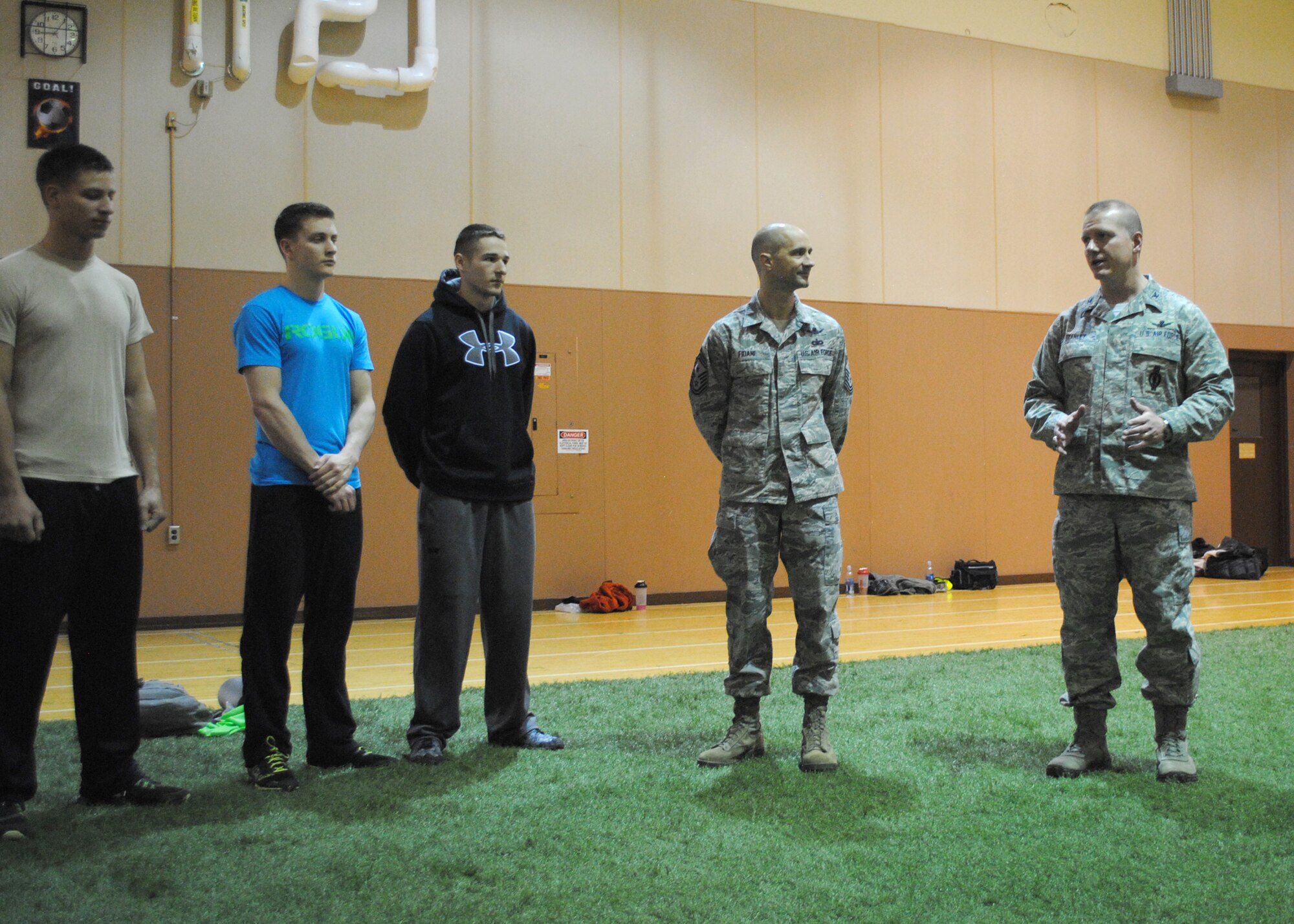 Col. Robert Stanley, 341st Missile Wing commander, and Chief Master Sgt. Frank Fidani, 341st MW command chief, speak to competitors in the Warrior Fit Competition at the fitness center Feb. 11. Stanley emphasized the importance of maintaining a high level of physical fitness for all service members. (U.S. Air Force photo/Airman 1st Class Katrina Heikkinen)