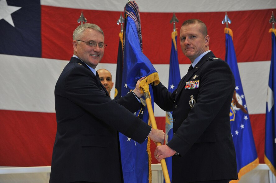 Maj. Gen. Michael Carey, 20th Air Force commander, presents the 341st Missile Wing guidon to Col. Robert Stanley, newly appointed 341st MW commander, during a change of command ceremony Feb. 8 at the 3-Bay Hangar. Stanley became the 35th commander in the wing’s history, succeeding Col. H.B. Brual. (U.S. Air Force photo/John Turner)