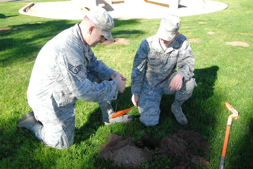 Staff Sgt. Andrew Carr, 56th Civil Engineer Squadron pest management journeyman, and Staff Sgt. Matthew Hulke, 56th CES pest management apprentice, set a gopher trap Feb. 4 at the air park on Luke Air Force Base. The Airmen from pest management handle various types of pests at Luke including ants, cockroaches, bees, birds and snakes. (U.S. Air Force photo/Airman 1st Class Grace Lee)