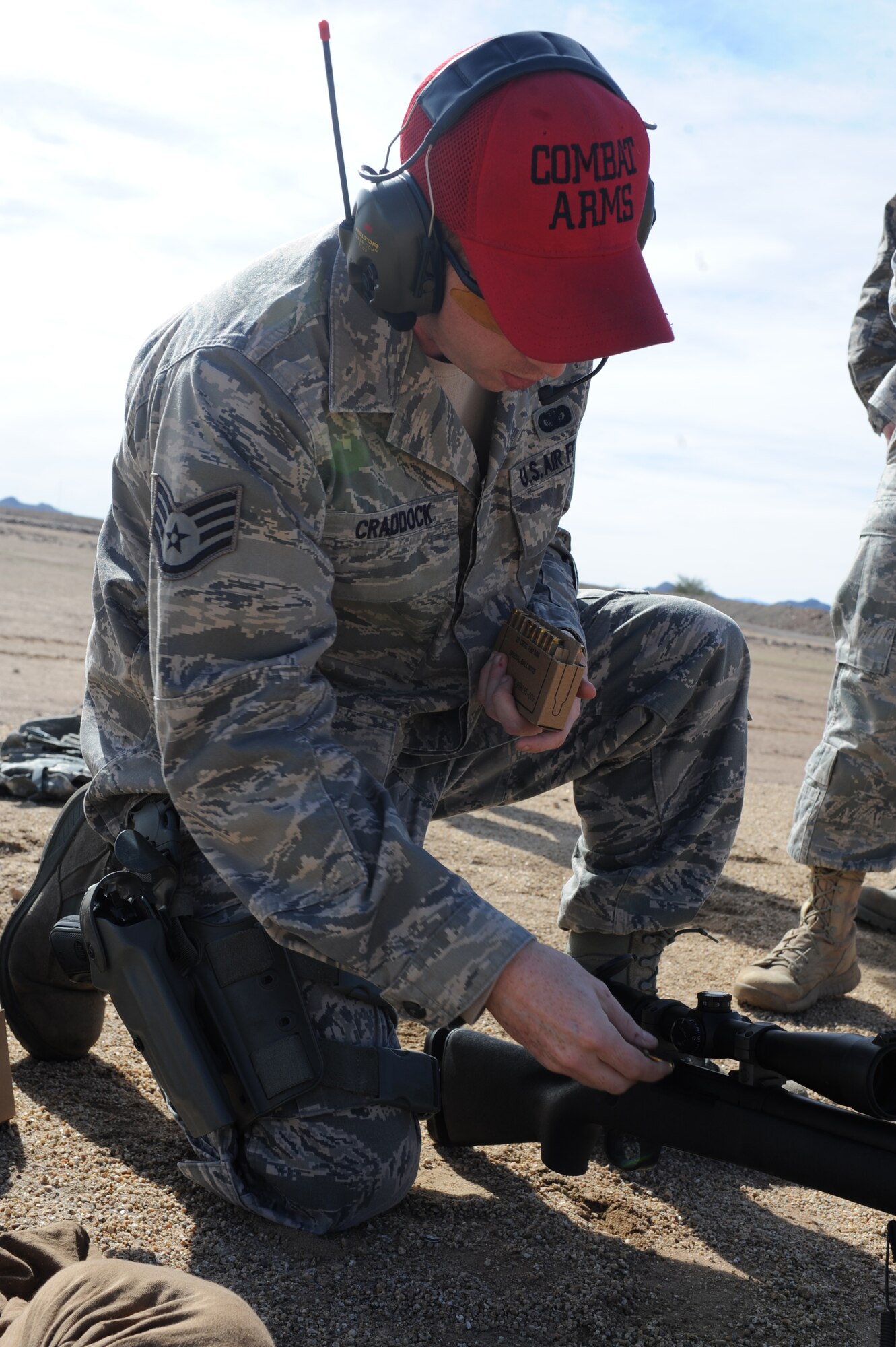 Staff Sgt. Brady Craddock, 56th SFS combat arms training instructor, loads ammunition into an M-24 rifle for the shooters during requalification training. Craddock ensures shooters perform with minimum to no mistakes. (U.S. Air Force photo/Airman 1st Class Devante Williams)