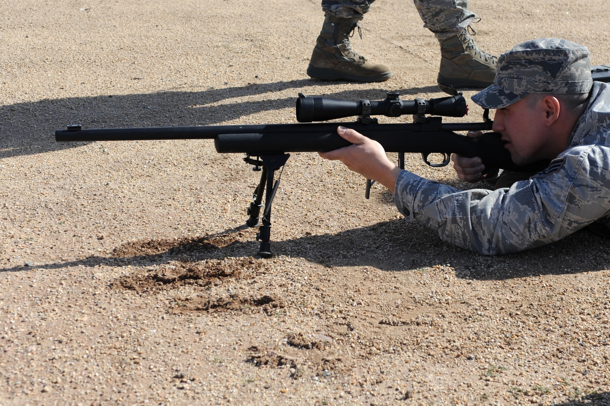 Senior Airman Gabriel Cuevas, 56th SFS pass and registration clerk, measures targets within the scope during his shooting requalification training at the Ben Avery Shooting Range. (U.S. Air Force photo/Airman 1st Class Devante Williams)