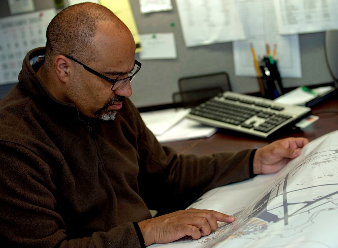 Mark Atlow, wing exercise plans specialist for the 633rd Air Base Wing Plans and Evaluations office, reviews a map at Langley Air Force Base Va. Jan 25, 2013 to make plans for an upcoming exercise. Atlow is in charge of managing local exercises for at Joint Base Langley-Eustis; a job that takes three to four months of planning per exercise. (U.S. Air Force Photo by Airman 1st Class R. Alex Durbin/Released)