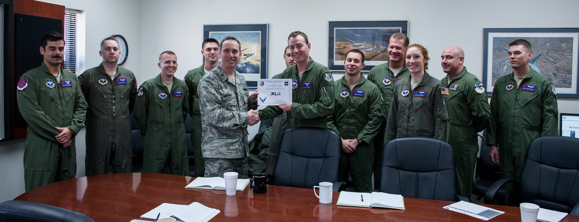 1st Lt. Timothy Nesbitt, 434th Flying Training Squadron assistant flight commander, poses with Col. Tom Murphy, 47th Flying Training Wing commander, after being presented the XLer of the week award at Laughlin Air Force Base, Texas, Jan. 30, 2013. The XLer is a weekly award chosen by wing leadership and given to those who consistently make outstanding contributions to Laughlin and their unit. (U.S. Air Force photo/Senior Airman Nathan Maysonet)