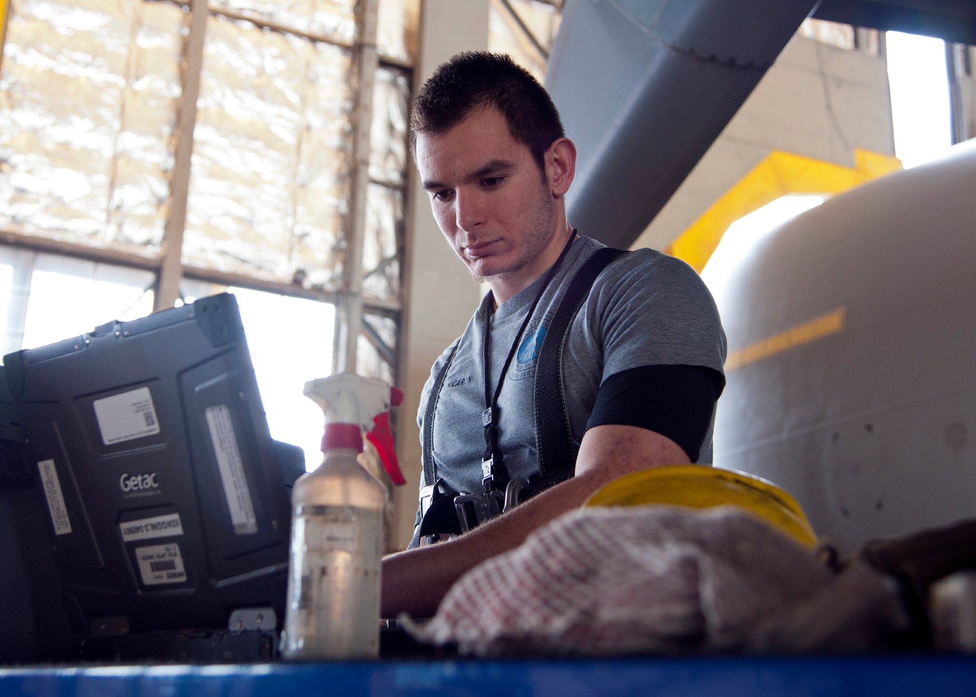 ALTUS AIR FORCE BASE, Okla. -- Brandon Caron, 97th Maintenance Directorate all purpose general mechanic intern, reviews technical orders before removing a flat pinge panel on a C-17 Globemaster III, Feb. 12, in an aircraft hangar. Caron is currently working as an intern for the 97th MX through the Grow Your Own Mechanic program. The GYOM program is an aircraft maintenance technician internship program. It was developed in 1999 under the Student Education Employment Plan in cooperation with the Southwest Technology Center’s Aviation and Aerospace program, providing aerospace jobs to the local area. (U.S. Air Force photo by Senior Airman Kenneth W. Norman / Released)