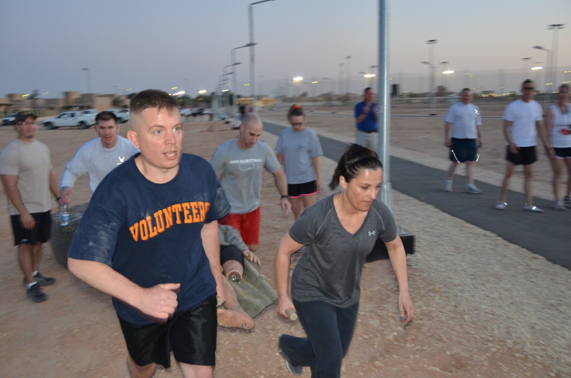 Capt. Steven Vanden Bos, Senior Master Sgt. Dan Farmer, Capt. Jeffrey Pelehac, and Master Sgt. Lisa Castillo, carry a 165-pound litter, Jan. 25, in the combat obstacle challenge. All are members of the 64th Expeditionary Support Squadron. Members of the 64th Air Expeditionary Group competed in the annual three-day Commander's Cup in Southwest Asia. Events included M-16A2 assault rifle assembly, carrying sand bags, pushing a HMMWV, a home run derby, firefighter's challenge and others before a final steak cookout. (U.S. Air Force photo/Capt. Justin Nikodem)