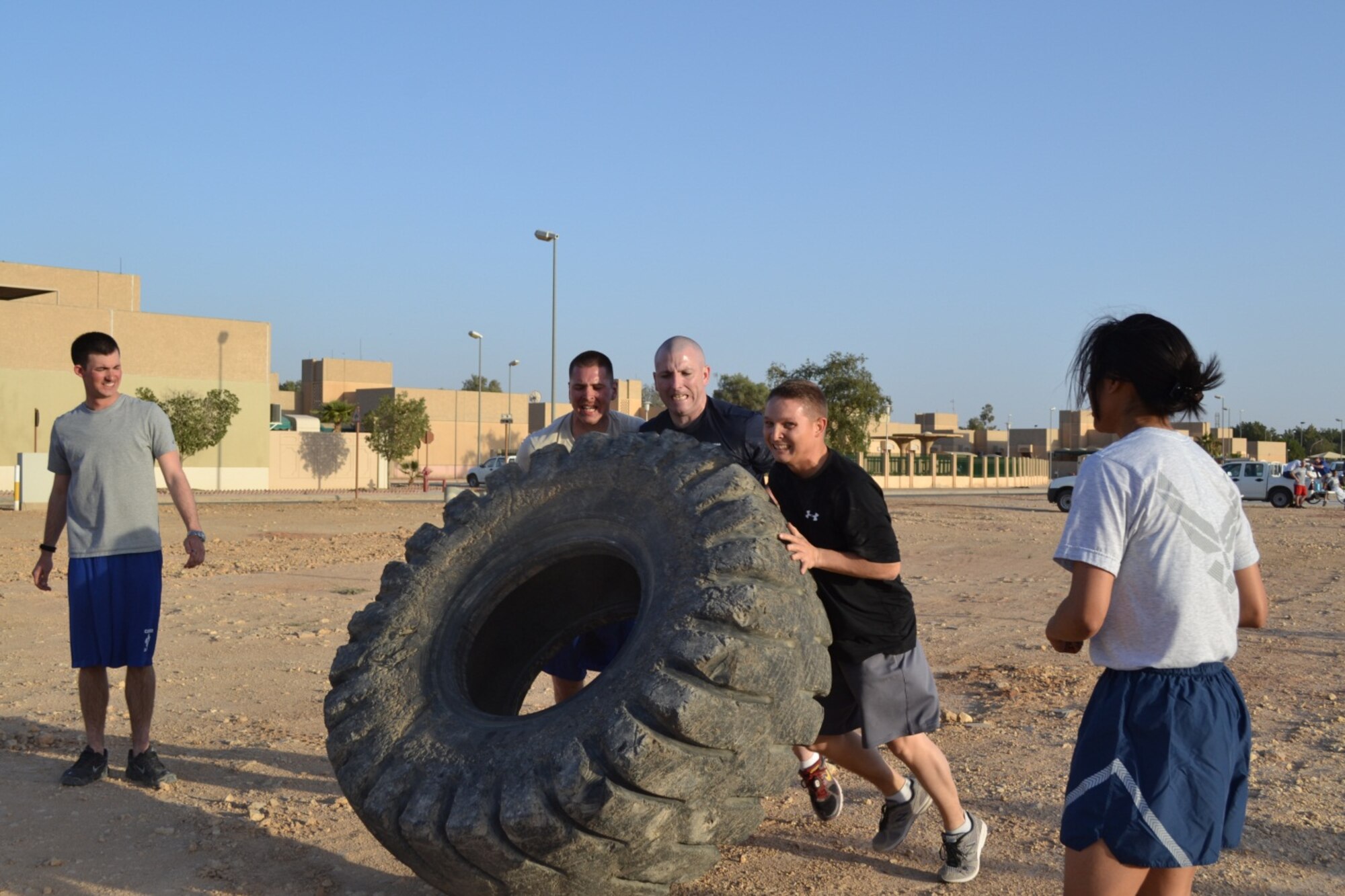 Staff Sgt. Matthew Garrette, Senior Master Sgt. Phillip Monk, Staff Sgt. Stephen Waite, and Airman 1st Class Jessica Navarro represent the 64th Expeditionary Support Squadron, Jan. 25, in the combat obstacle course. Members of the 64th Air Expeditionary Group competed in the annual three-day Commander's Cup in Southwest Asia. Events included M-16A2 assault rifle assembly, carrying sand bags, pushing a HMMWV, a home run derby, firefighter's challenge and others before a final steak cookout. (U.S. Air Force photo/Chief Master Sgt. Jim Dowell)