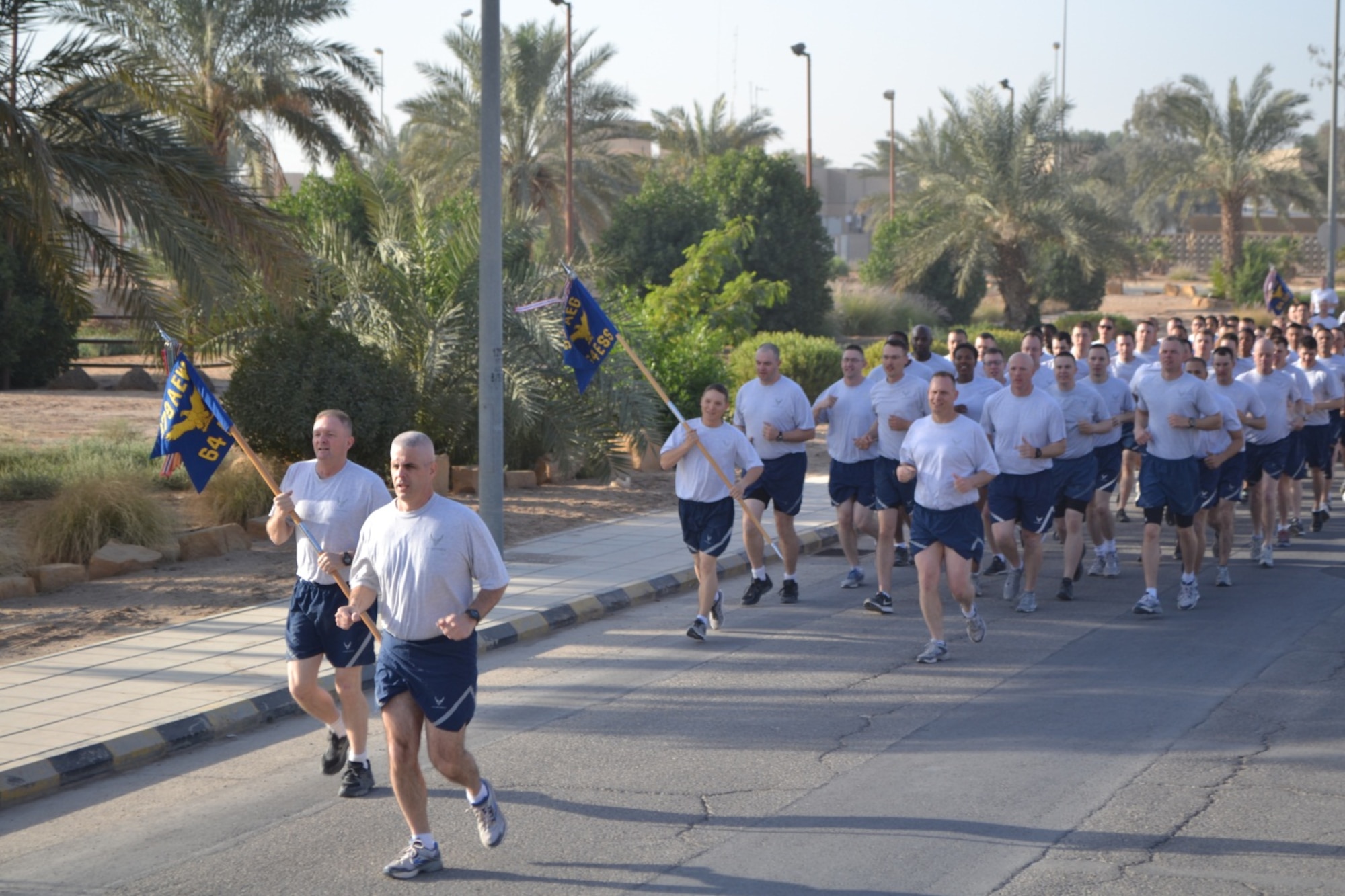 Col. Michael Florio, 64th Air Expeditionary Group Commander, leads the group in a formation run, Jan. 25, to begin the Commander’s Cup competition. Members of the group competed in the annual three-day Commander's Cup in Southwest Asia. Events included M-16A2 assault rifle assembly, carrying sand bags, pushing a HMMWV, a home run derby, firefighter's challenge and others before a final steak cookout. (U.S. Air Force photo/ Staff Sgt. Cynthia Brockes)