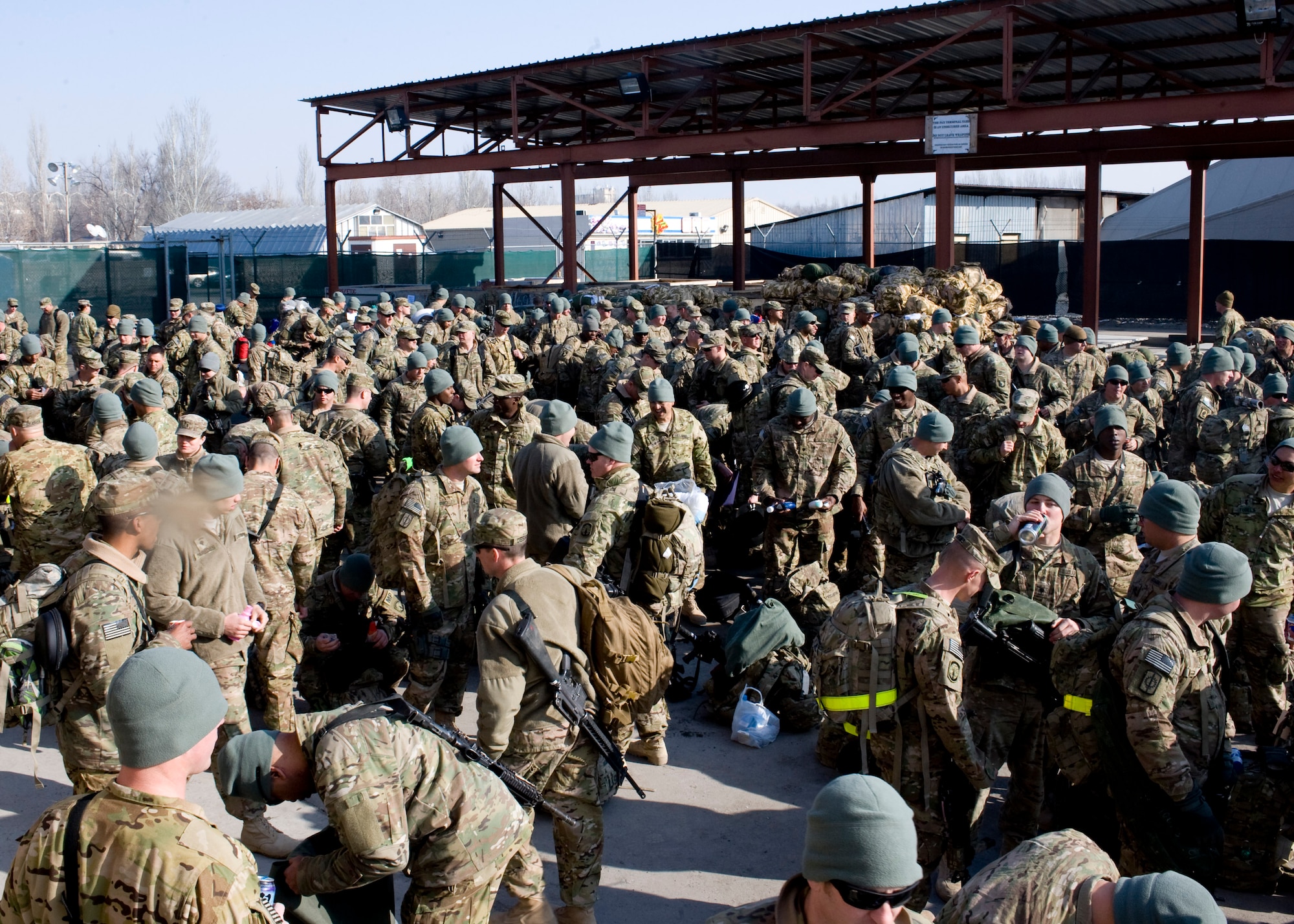U.S. troops stand in the 376th Expeditionary Customs Processing yard Feb. 14, 2013, at Transit Center at Manas, Kyrgyzstan. In the last year, the customs office has processed more than 200,000 passengers, screening as many as 1,900 individuals and their baggage in a single 24-hour period. (U.S. Air Force photo/Staff Sgt. Stephanie Rubi) 