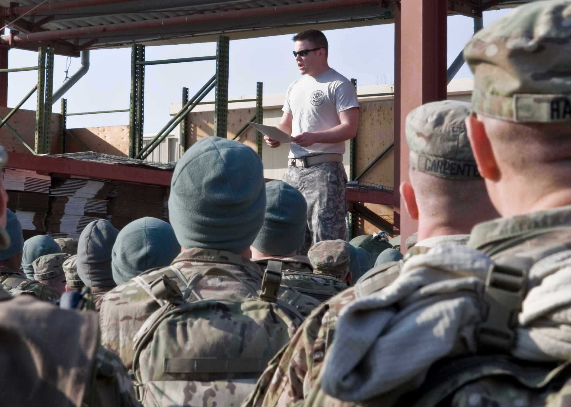 U.S. Army Spc. Gary Bishop, 304th Military Police Battalion; Detachment 5, customs and border patrol agent, briefs Soldiers Feb. 14, 2013, at Transit Center at Manas, Kyrgyzstan. The briefing reviews items service members are authorized to carry onto the aircraft; once the briefing is concluded, troops are given a 15-minute amnesty period to dispose of any prohibited items they may have. Bishop is deployed from Nashville, Tenn., and is a native of Soddy Daisy, Tenn. (U.S. Air Force photo/Staff Sgt. Stephanie Rubi)