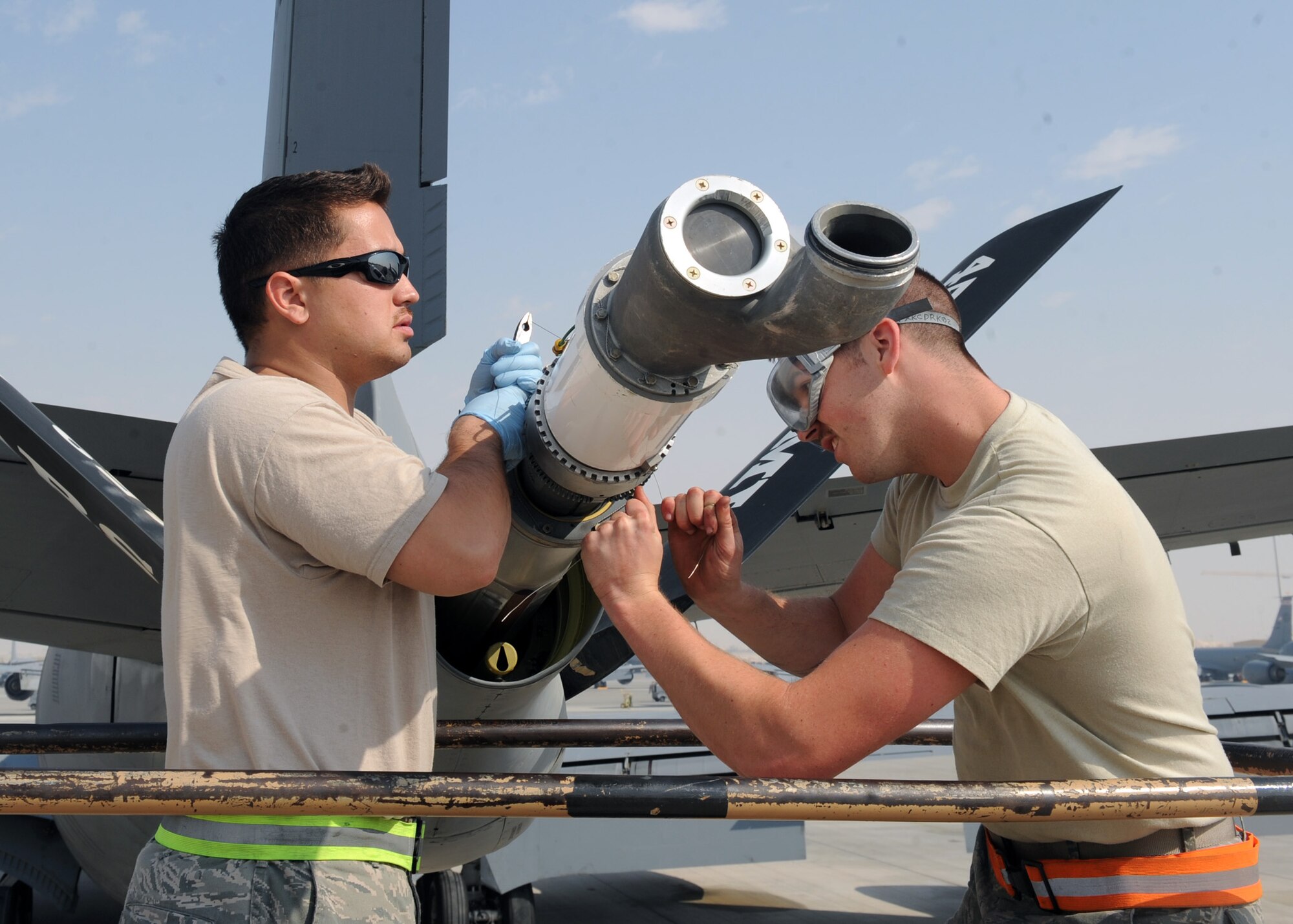 SOUTHWEST ASIA – From left, Staff Sgt. Benne Baumann and Senior Airman Lance McFairland install a drogue assembly on a KC-135’s boom Feb. 13. The assembly will allow the aircraft to provide fuel to NATO and U.S. Navy aircraft. Both Airmen are crew chiefs assigned to the 340th Aircraft Maintenance Unit. Baumann and McFairland are both deployed from the 22nd Maintenance Group at McConnell Air Force Base, Kan. (U.S. Air Force photo by Senior Airman Joel Mease)