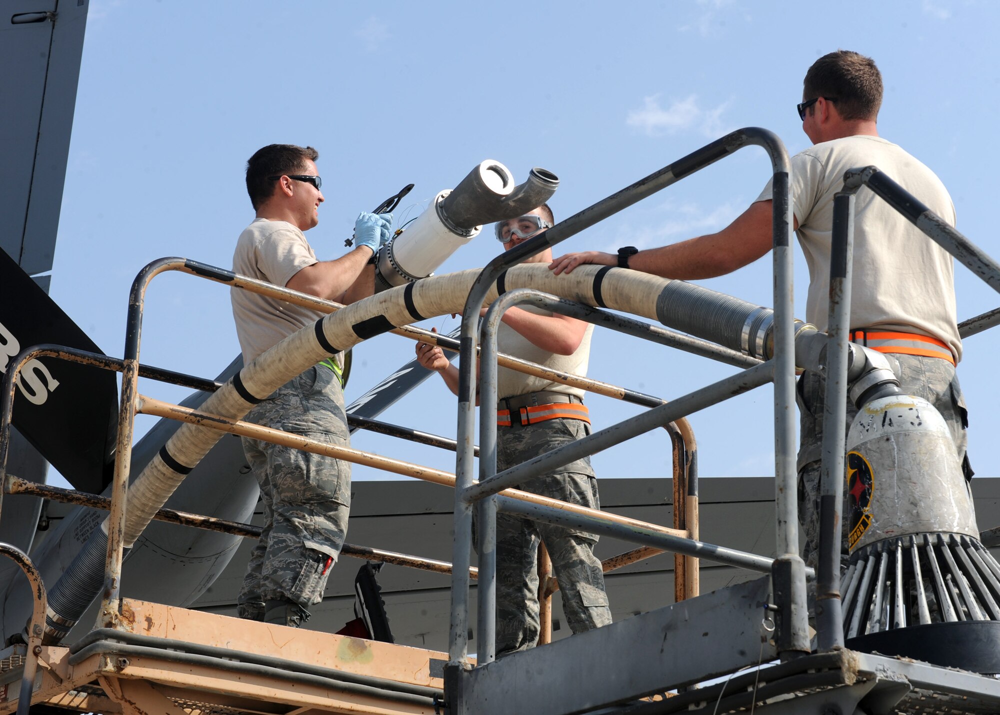 SOUTHWEST ASIA – From left, Staff Sgt. Benne Baumann, Senior Airman Lance McFairland and Senior Airman Josh Allison install a drogue assembly on a KC-135’s boom Feb. 13. The assembly will allow the aircraft to provide fuel to NATO and U.S. Navy aircraft. All three of the Airmen are crew chiefs assigned to the 340th Aircraft Maintenance Unit. Baumann and McFairland are both deployed from the 22nd Maintenance Group at McConnell Air Force Base, Kan. Allison is deployed from the 911 Air Refueling Squadron at Seymour Johnson Air Force Base, N.C. (U.S. Air Force photo by Senior Airman Joel Mease)