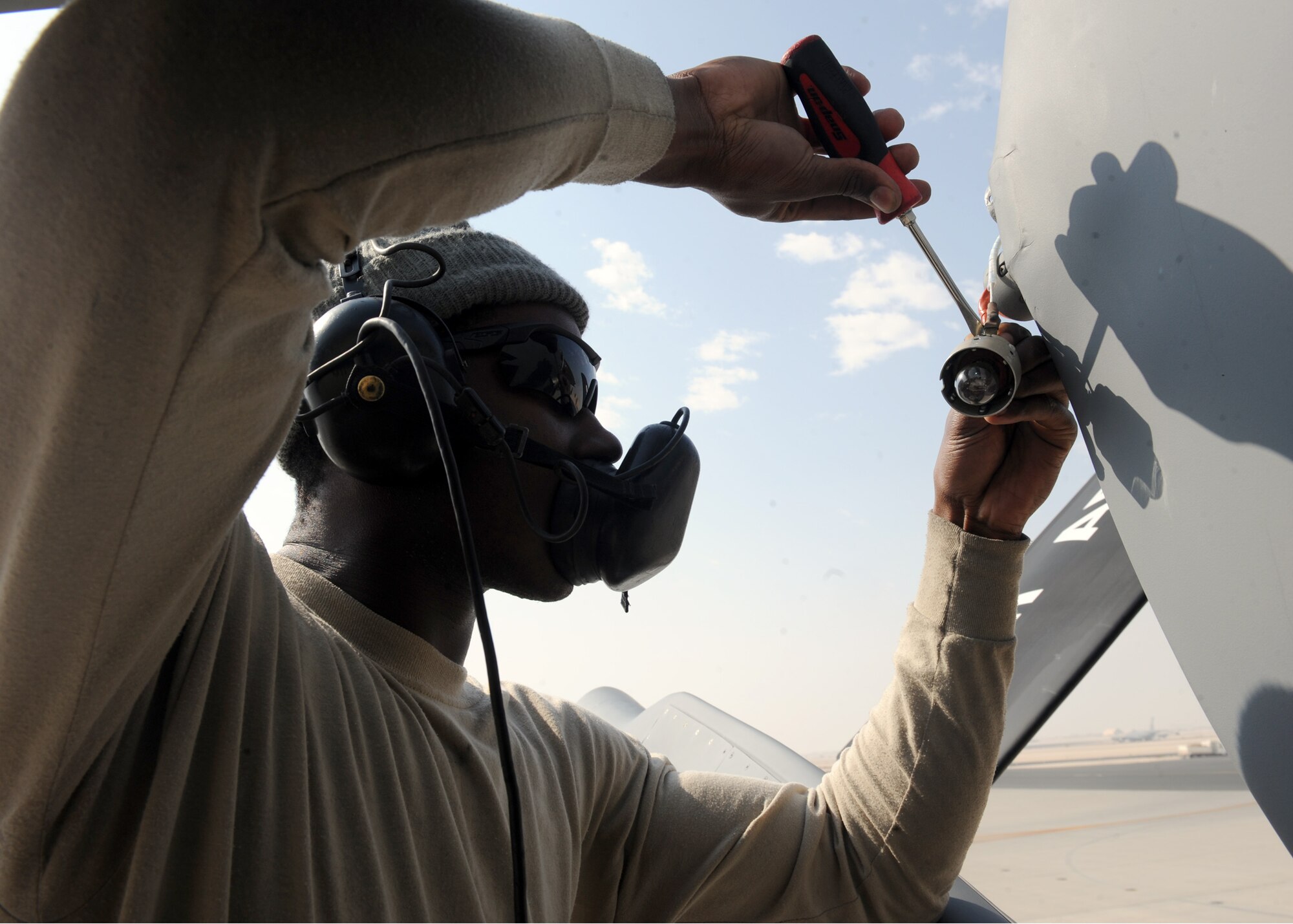 SOUTHWEST ASIA – Airman First Class Michael Jenkins, 340th Aircraft Maintenance Unit electrician, repairs a defective wire on a on a tail cone navigation light of KC-135 Feb. 13. While in theatre, electricians do more than wire repair, environmental component installation or removal, and oxygen system troubleshooting. They also perform production team duties such as launching aircraft. Jenkins is deployed from the 6th Aircraft Maintenance Squadron at MacDill Air Force Base, Fla. (U.S. Air Force photo by Senior Airman Joel Mease)