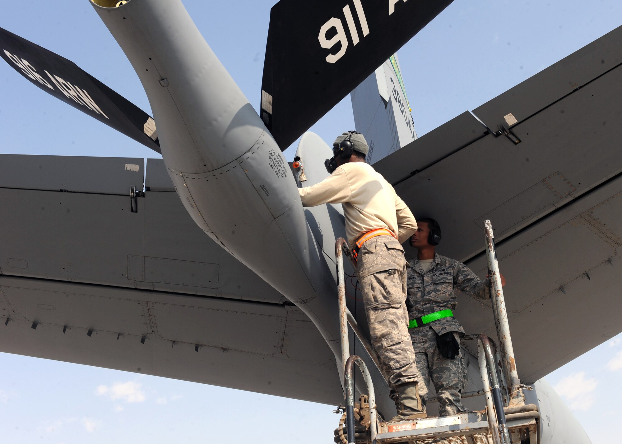 SOUTHWEST ASIA – From left, Airman First Class Michael Jenkins, 340th Aircraft Maintenance Unit electrician, and Airman First Class Joshua Thomas, 340th AMU electrician troubleshoot a tail cone navigation light malfunction on the tail of a KC-135 here Feb. 13. This position light is necessary to avoid mid-air collision during night time in-flight air refueling operations. Jenkins is deployed from the 6th Aircraft Maintenance Squadron at MacDill Air Force Base, Fla., and Thomas is deployed from the 22nd Aircraft Maintenance Squadron at McConnell Air Force Base, Kan. (U.S. Air Force photo by Senior Airman Joel Mease)