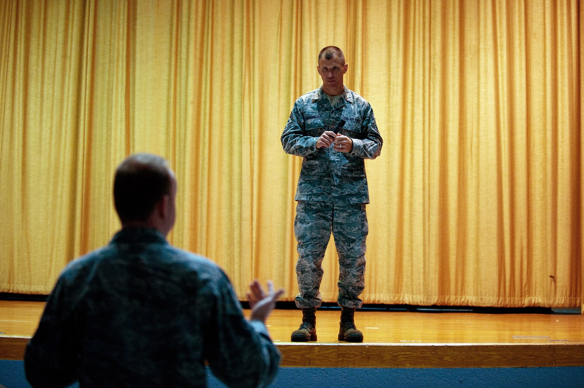 Chief Master Sgt. Steve McDonald listens to an Airman’s question Feb. 8, 2013, during an all-call at Yokota Air Base’s theater.  McDonald said he was at Yokota to hear what was on Airmen’s minds and to engage them on current Air Force topics. (U.S. Air Force photo by Airman 1st Class Meagan Schutter) 