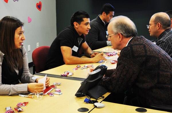 Employees Noemi Rodriquez (front left) and Jonathan Machorro (back left) meet mentors Norman Boeman (front right) and Ned Araujo (back right) speed-dating style during a mentoring-matchmaking process at the Los Angeles District office Feb. 13. 