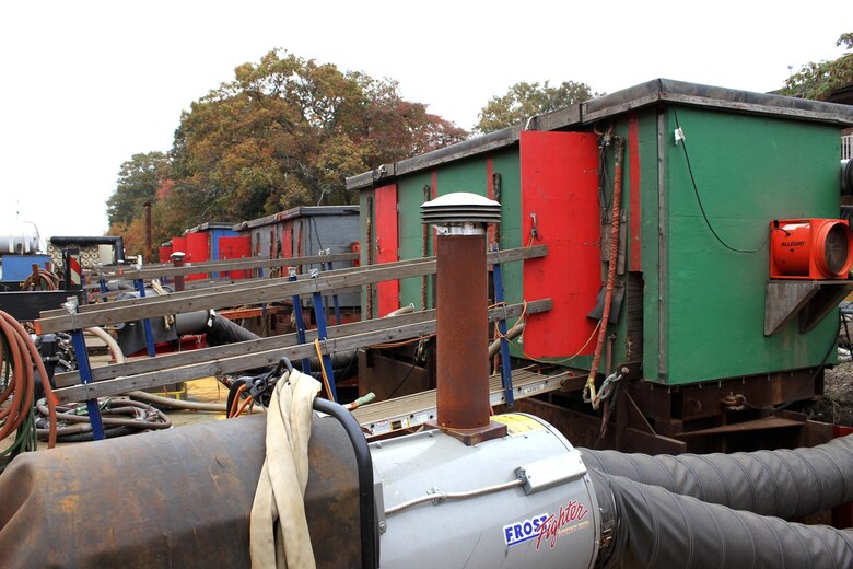 Moveable coffer dams, temporary watertight enclosures, are positioned against the Point Pleasant Canal bulkhead, and contractors pump the area dry to expose the length of the steel bulkhead and make repairs possible.