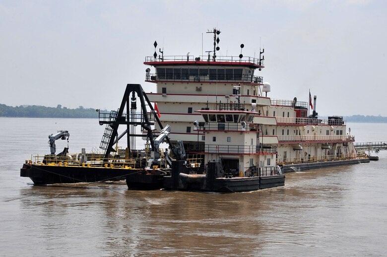 A tender comes alongside the Dredge Hurley during routine operation.