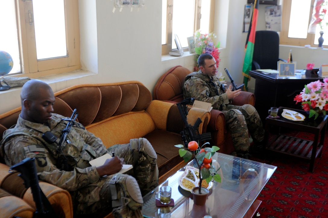 U.S. Army Capt. Timothy Walton, right, and U.S. Army Pfc. Gimbala Sankare, left, conduct a meeting with the Marawara district governor in the Marawara District Center in Kunar province, Afghanistan, Feb. 7, 2013. Walton and Sankare are assigned to the 101st Airborne Division's Headquarters Company, 2nd Battalion, 327th Infantry Regiment, 1st Brigade Combat Team.