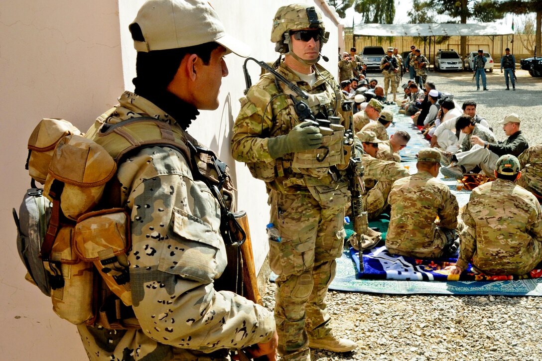 Army Pfc. Brian J. Ure, center, and an Afghan border policeman, left ...