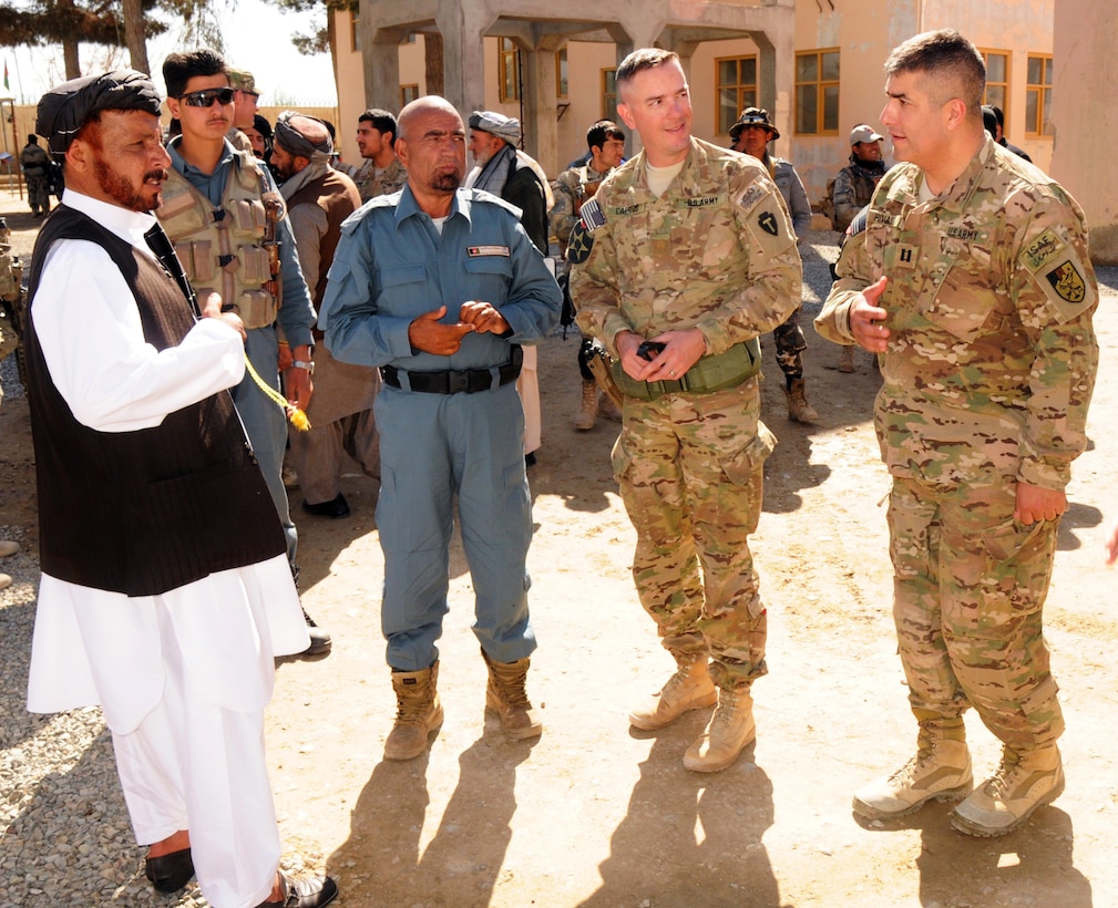 U.S. Army Maj. Brian Carrico, second right, and U.S. Army Cpt. Gavino Rivas, right, greet Afghan uniform police commanders after the first district leaders' shura in Spin Boldak in Kandahar province, Afghanistan, Feb. 11, 2013. Carrico is commander of Security Force Assistance Team Tombstone, and Rivas, an advisor for the ruleof law, is assigned to the 2nd Battalion, 23rd Infantry Regiment.