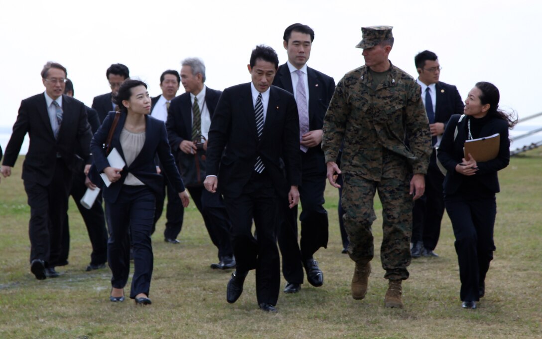 Fumio Kishida is met and escorted by Col. Jonathan D. Covington to the site where Hirofumi Takeda, director general of Okinawa Defense Bureau gave a brief on the Marine Corps Air Station Futenma Relocation Facility Feb. 16. Covington is the deputy commander for MCIPAC. Kishida is the Minister for Foreign Affairs of the Government of Japan. 