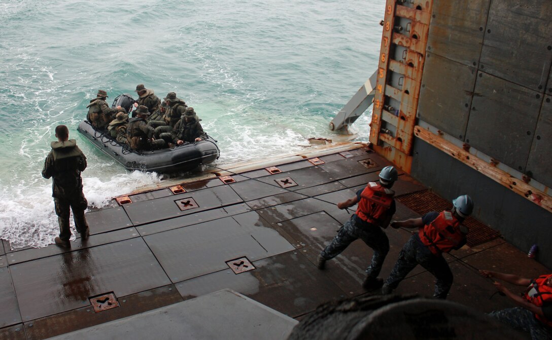 Sailors of the USS Tortuga (LSD-46) help pull in a combat rubber raid craft with Marines from Company B., Battalion Landing Team 1st Battalion, 5th Marine Regiment, 31st Marine Expeditionary Unit, here, Feb. 15. The Marines conducted a bilateral boat raid alongside Royal Thai Marines as part of exercise Cobra Gold 2013. Cobra Gold is an annual exercise that includes numerous multilateral events ranging from amphibious assaults to non-combatant evacuation operations. The training aims to improve interoperability between the United States, the Kingdom of Thailand, and many other participating countries. The 31st MEU is the only continuously forward-deployed MEU and is the Marine Corps’ force in readiness in the Asia-Pacific region.
