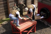 Teachers and counselors from Recruiting Station Twin Cities work together to complete one of the 12 Stall obstacles at Camp Pendleton Jan. 31. Educators attending a workshop had the opportunity to complete the same obstacles recruits encounter during the Crucible. For additional imagery from the event, visit www.facebook.com/rstwincities.
