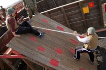 Teachers and counselors from Recruiting Station Twin Cities work together to complete one of the 12 Stall obstacles at Camp Pendleton Jan. 31. Educators attending a workshop had the opportunity to complete the same obstacles recruits encounter during the Crucible. For additional imagery from the event, visit www.facebook.com/rstwincities.