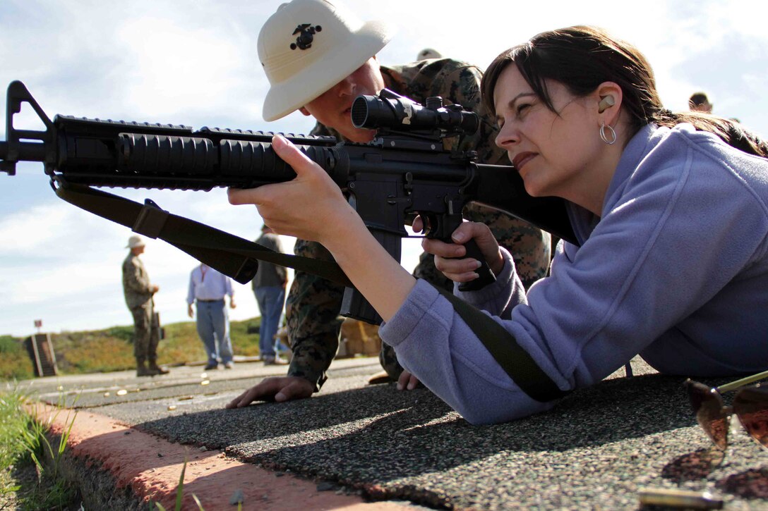 A primary marksmanship instructor advises an educator from Recruiting Station Kansas City on how to properly sight in on her target Jan. 31. Nearly 80 teachers and counselors were able to shoot live rounds during an educators workshop. For additional imagery from the event, visit www.facebook.com/rstwincities.