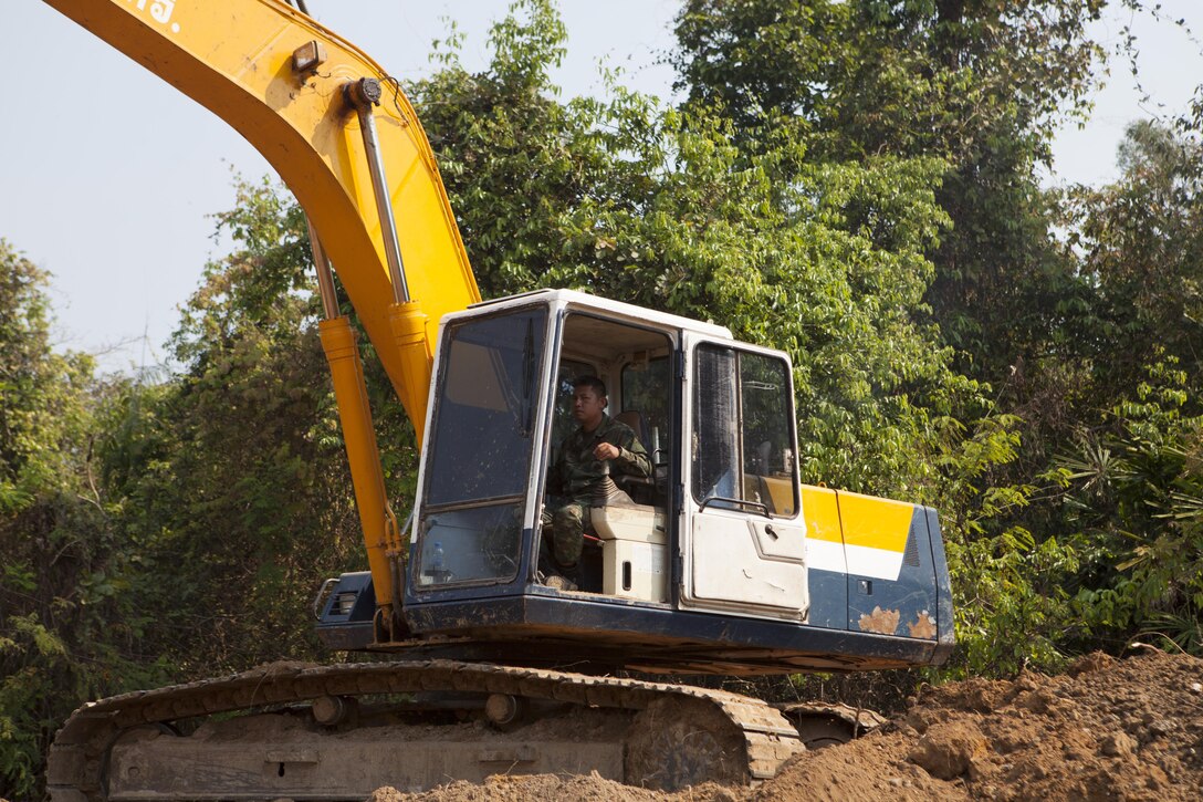 A Royal Thai Marine uses his excavator to remove excess dirt from the future site of an explosive ordnance demolition site Feb. 14 at Ban Chan Krem, Kingdom of Thailand. The construction is part of field training during exercise Cobra Gold 2013 and future expansion of the training range at Ban Chan Krem. Cobra Gold is a recurring, multinational and multiservice exercise hosted annually by Thailand and developed by the Thai and U.S. militaries. The Royal Thai Marinesâ€™ engineer section plays a vital role in the range expansion because of their knowledge of the land and their access to equipment. Thai Marine engineers are working with the Combat Assault Battalion, 4th Marine Regiment, 3rd Marine Division, III Marine Expeditionary Force.