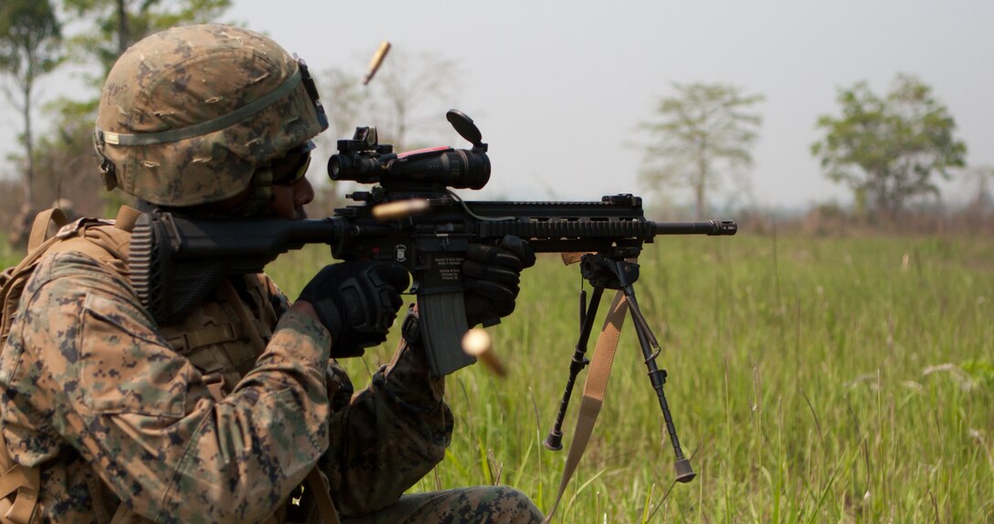 A U.S. Marine infantry automatic rifleman takes a knee and sends rounds down range during a live-fire platoon attack drill alongside U.S. Marines Feb. 13 in Ban Chan Krem, Kingdom of Thailand, during the field training portion of exercise Cobra Gold 2013. CG 13, in its 32nd iteration, is an annual Thai-U.S. co-sponsored exercise, which focuses on interoperability of forces and readiness, bolstering national partnerships and regional security in the Asia-Pacific region. The U.S. Marine is with Company A, 1st Battalion, 3rd Marines. The battalion is attached to 4th Marines, 3rd Marine Division, III Marine Expeditionary Force, as part of the Marine Corps unit deployment program.  (U.S. Marine Corps photo by Cpl. Matthew A. Callahan)