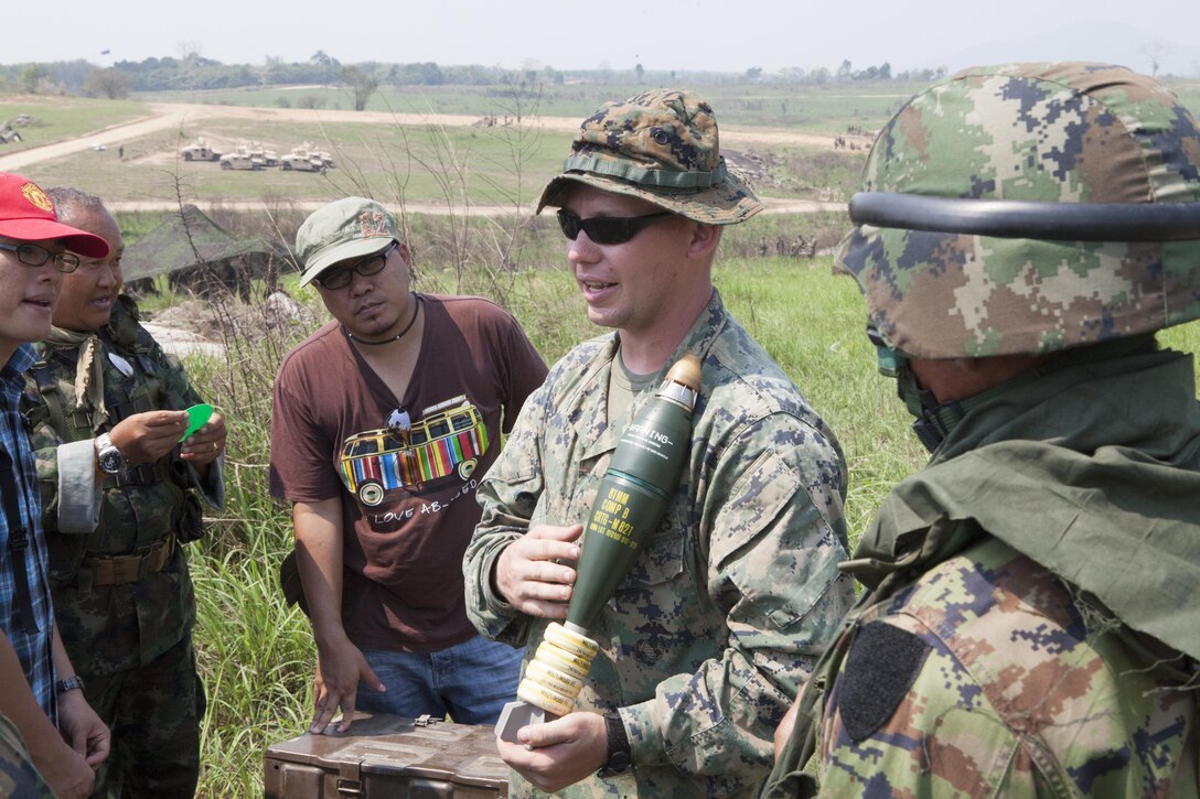 U.S. Marine Sgt. Chad R. Pauls, center, shows members of the Royal Thai Marines an 81mm mortar round and explains the differences between Thai and U.S. Marine ordnance Feb. 12 during the Cobra Gold 2013 field training exercises in Ban Chan Krem, Kingdom of Thailand. U.S. involvement in CG 13 demonstrates commitment to building military-to-military interoperability with participating nations and to supporting peace and stability in the region. Royal Thai Marines are with 3rd Battalion, 1st Infantry. Pauls is a mortarman and squad leader with Weapons Company, 1st Battalion, 3rd Marine Regiment. The battalion is attached to 4th Marines, 3rd Marine Division, III Marine Expeditionary Force, as part of the Marine Corps unit deployment program.
