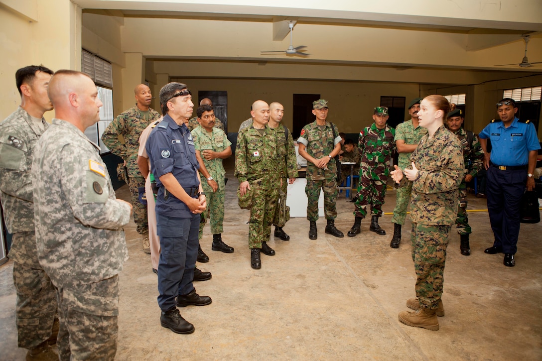 Multinational service members participating in a senior enlisted team-building activity receive a brief from U.S. Marine Capt. Stacie M. Piccinich, operations officer for the combined joint civil military operations task force at Camp Akatosrot, Phitsanulok province, Kingdom of Thailand, Feb. 12 during exercise Cobra Gold 2013. The two-day seminar allowed attendees to share past experiences, relate training styles, and offer advice to one another in a shared learning environment. Exercise Cobra Gold is the largest multinational exercise in the Asia-Pacific region and provides Thailand, the U.S., Singapore, Japan, Republic of Korea, Indonesia and Malaysia an opportunity to maintain relationships and enhance interoperability.